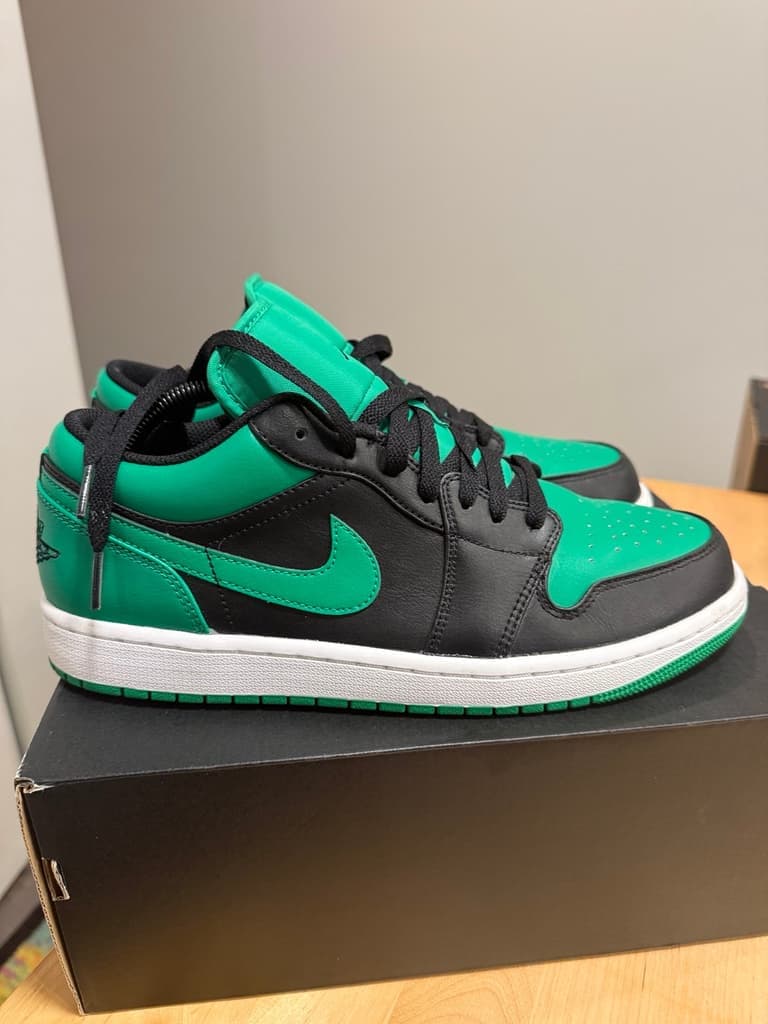 Black and green Air Jordan 1 Low sneakers on their box